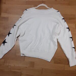 White sweater with stars.
